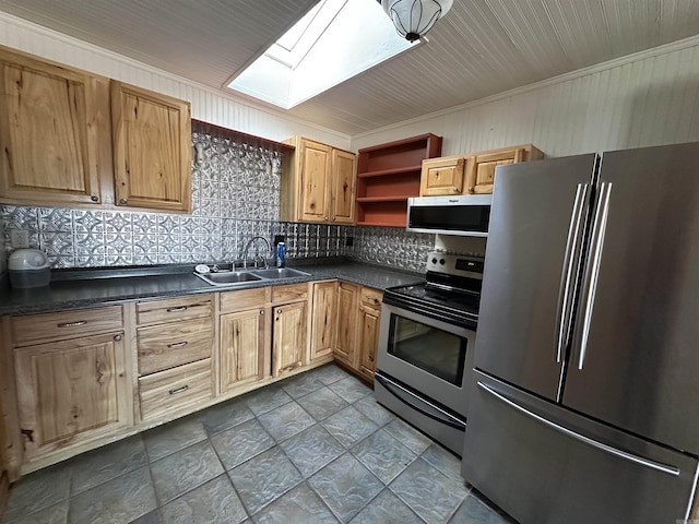 kitchen featuring appliances with stainless steel finishes, tasteful backsplash, a skylight, ornamental molding, and sink