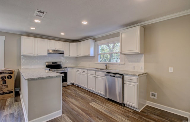 kitchen featuring appliances with stainless steel finishes, crown molding, sink, white cabinets, and hardwood / wood-style floors