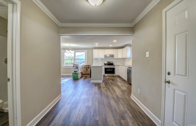 kitchen with crown molding, white cabinets, dark hardwood / wood-style floors, and appliances with stainless steel finishes