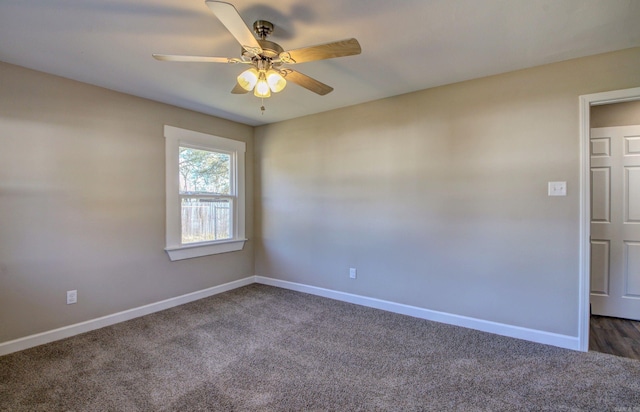 unfurnished room featuring dark colored carpet and ceiling fan