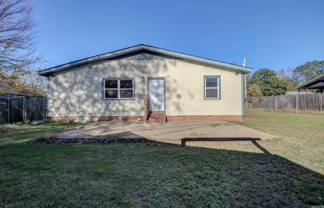 back of property featuring a lawn and a patio area