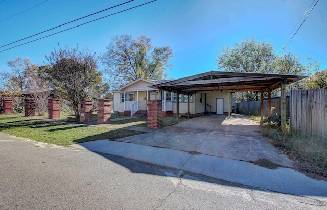 view of front of home with a carport and a front lawn