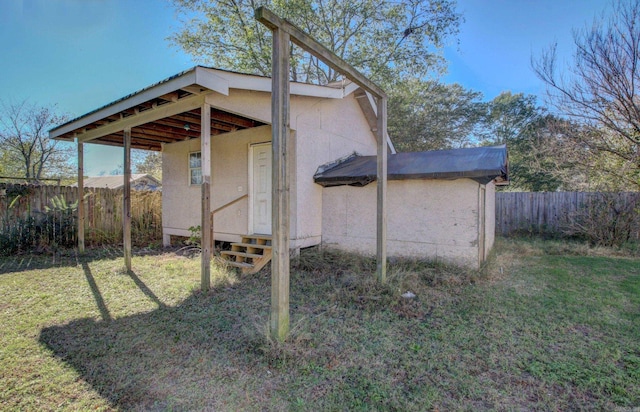 view of outbuilding with a lawn