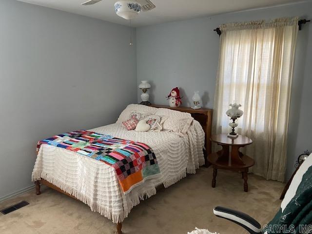 bedroom featuring ceiling fan and light colored carpet