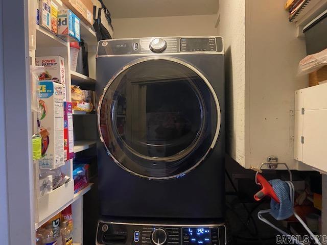 laundry room with stacked washer / dryer