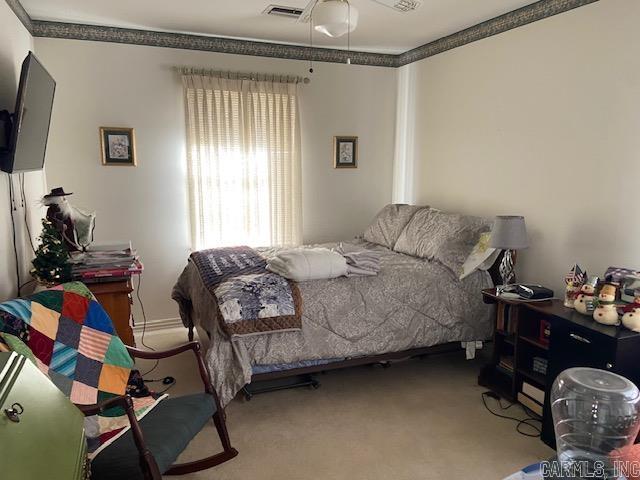 carpeted bedroom with ceiling fan