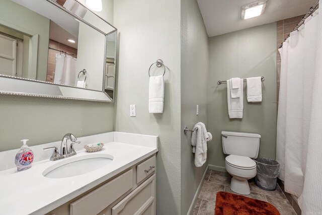 bathroom featuring tile patterned floors, vanity, and toilet