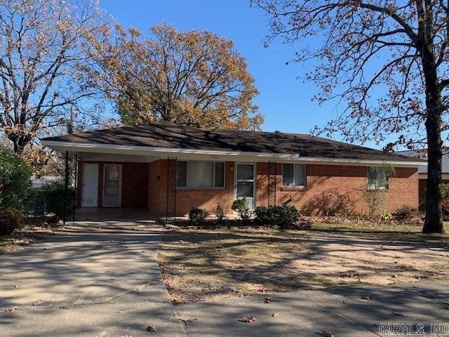 single story home featuring a carport