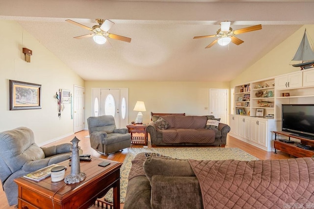 living room with ceiling fan, light hardwood / wood-style flooring, and lofted ceiling