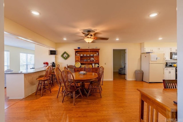 dining space featuring ceiling fan and light wood-type flooring