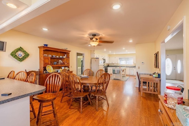 dining space featuring ceiling fan, plenty of natural light, french doors, and light hardwood / wood-style flooring