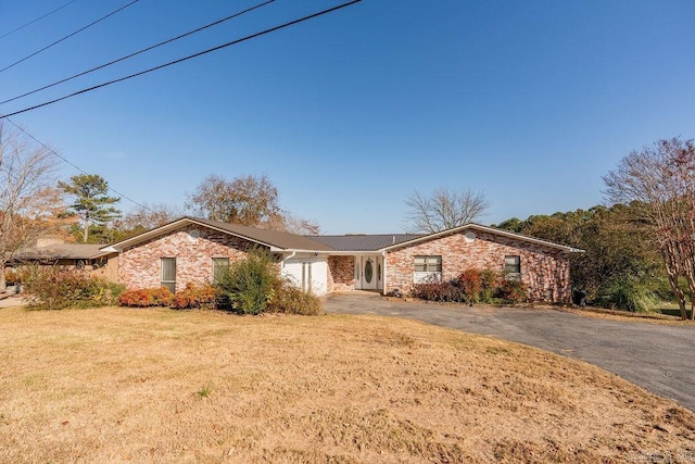 ranch-style home with a front yard and a garage