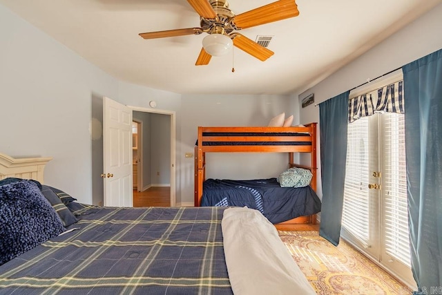 bedroom featuring ceiling fan and multiple windows