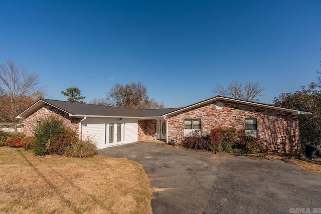 ranch-style house with french doors and a front lawn