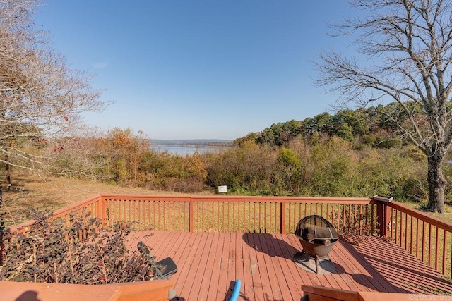 wooden terrace featuring a fire pit