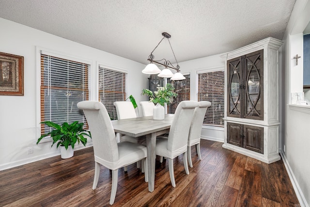 dining room featuring dark hardwood / wood-style floors and a textured ceiling