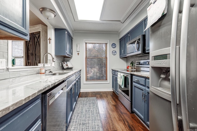 kitchen with sink, blue cabinets, dark hardwood / wood-style floors, and appliances with stainless steel finishes