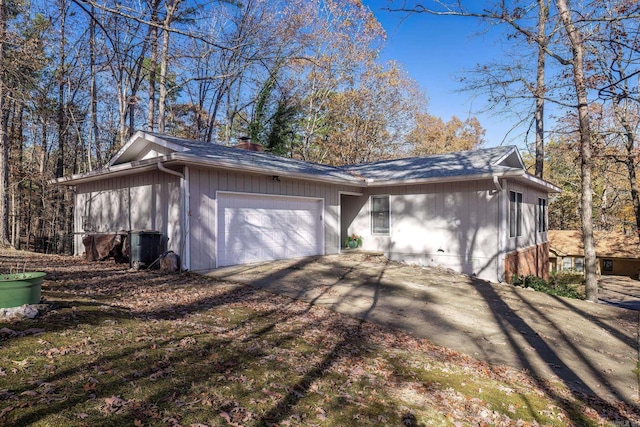 view of home's exterior with central AC and a garage