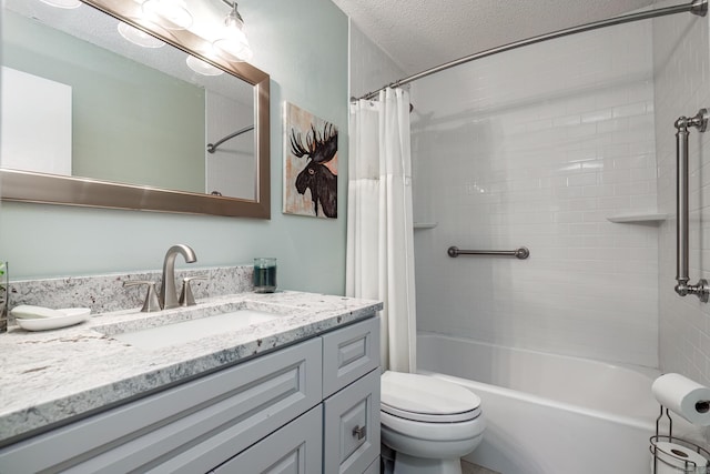 full bathroom featuring shower / bath combo, vanity, a textured ceiling, and toilet