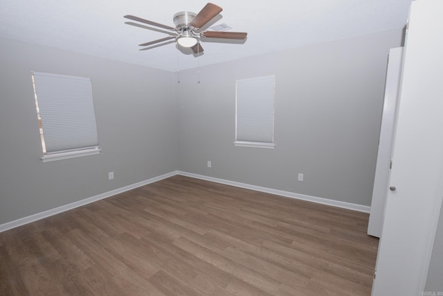 spare room with hardwood / wood-style floors and ceiling fan