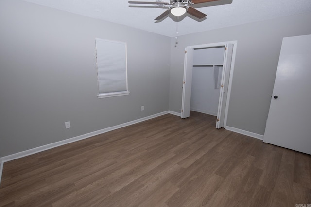 unfurnished bedroom featuring ceiling fan and dark hardwood / wood-style flooring