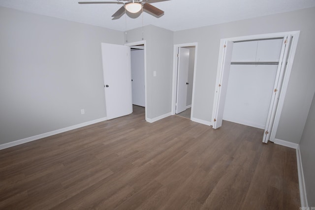 unfurnished bedroom with a closet, ceiling fan, and dark wood-type flooring