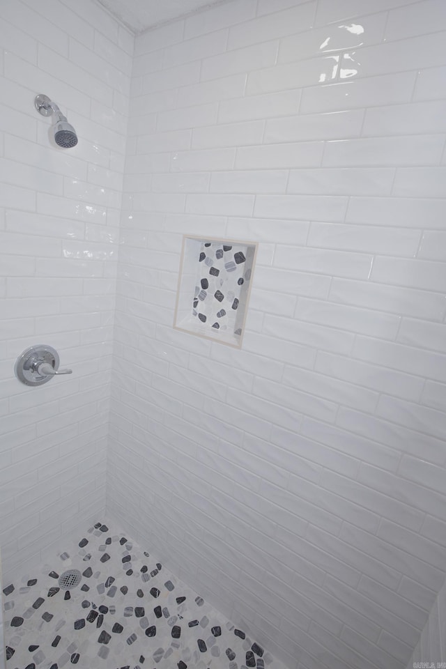 bathroom with tiled shower