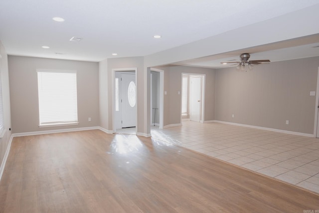 interior space featuring ceiling fan, a healthy amount of sunlight, and light hardwood / wood-style flooring