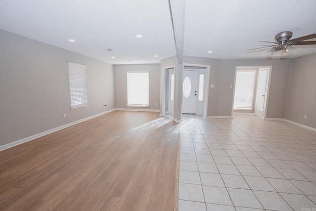 interior space featuring beam ceiling, light hardwood / wood-style flooring, and ceiling fan