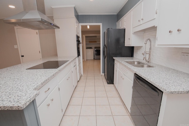 kitchen with black appliances, sink, wall chimney exhaust hood, light stone countertops, and white cabinetry