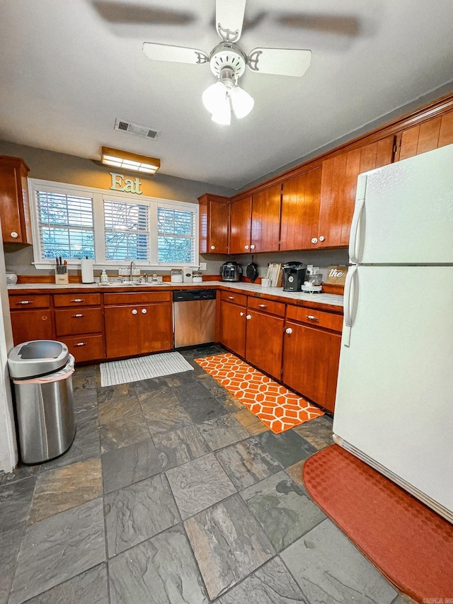 kitchen featuring sink, dishwasher, ceiling fan, and white refrigerator