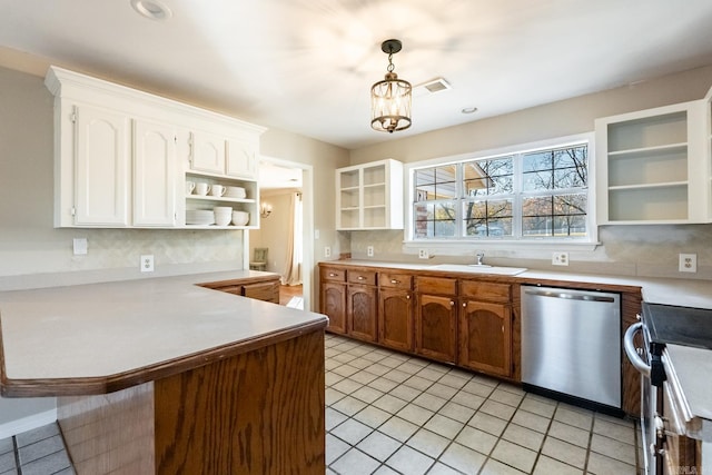 kitchen featuring an inviting chandelier, kitchen peninsula, hanging light fixtures, appliances with stainless steel finishes, and white cabinetry