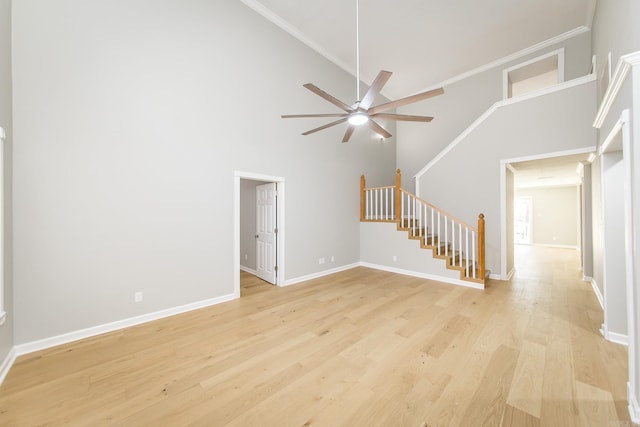 unfurnished living room featuring ceiling fan, light hardwood / wood-style floors, and high vaulted ceiling