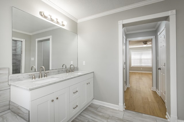 bathroom with hardwood / wood-style floors, vanity, crown molding, and a textured ceiling