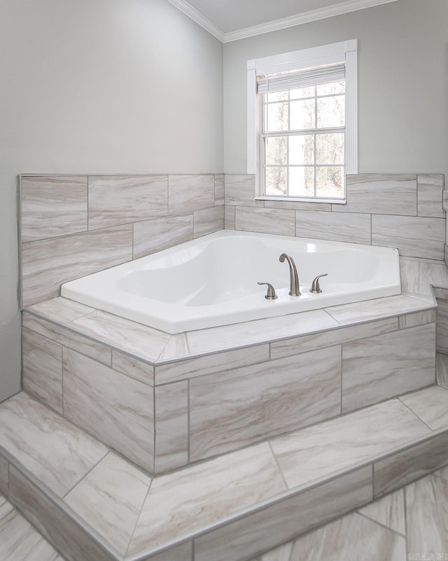 bathroom featuring tiled tub and crown molding