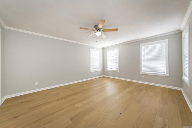 spare room featuring ceiling fan, light wood-type flooring, and crown molding