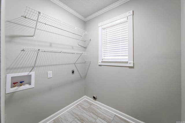 clothes washing area featuring hookup for an electric dryer, crown molding, and washer hookup