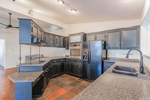 kitchen featuring kitchen peninsula, a textured ceiling, sink, black appliances, and lofted ceiling