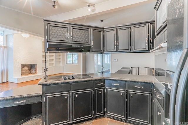 kitchen with stainless steel fridge with ice dispenser, black electric cooktop, a wealth of natural light, and ornamental molding