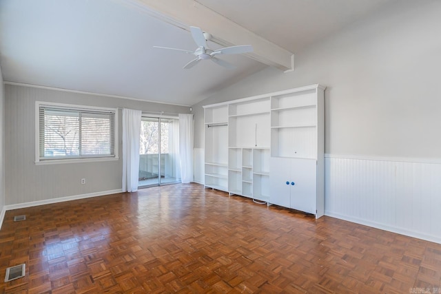 unfurnished living room with dark parquet flooring, lofted ceiling with beams, and ceiling fan