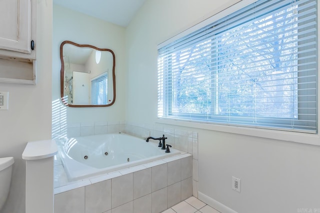 bathroom featuring tile patterned flooring and a relaxing tiled tub