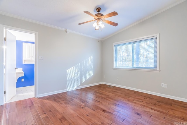 unfurnished room with vaulted ceiling, light hardwood / wood-style flooring, ceiling fan, and crown molding