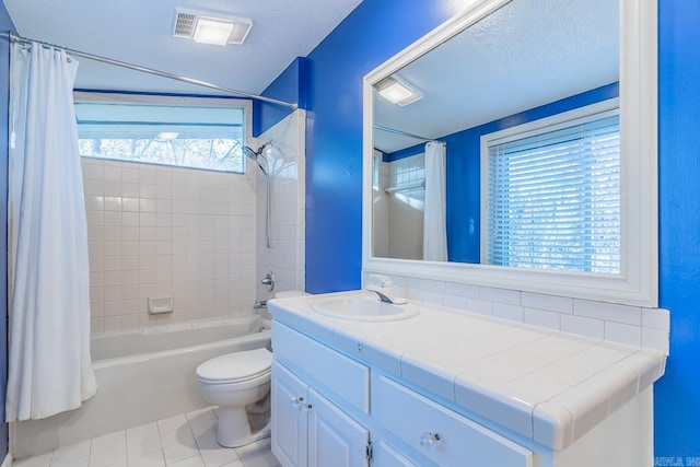 full bathroom featuring toilet, a textured ceiling, tile patterned floors, and a wealth of natural light