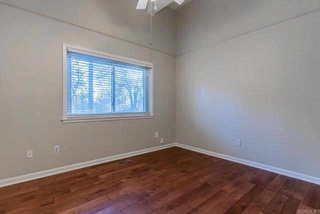 spare room featuring ceiling fan and dark hardwood / wood-style flooring