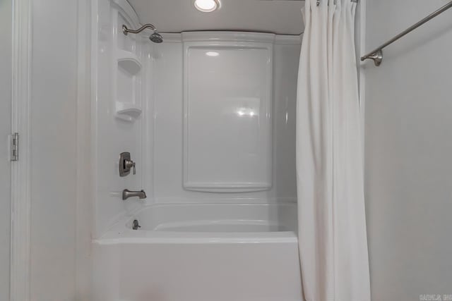 bathroom with shower / bath combo with shower curtain