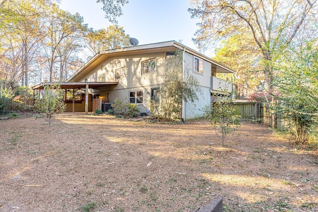 rear view of property with a carport and central AC