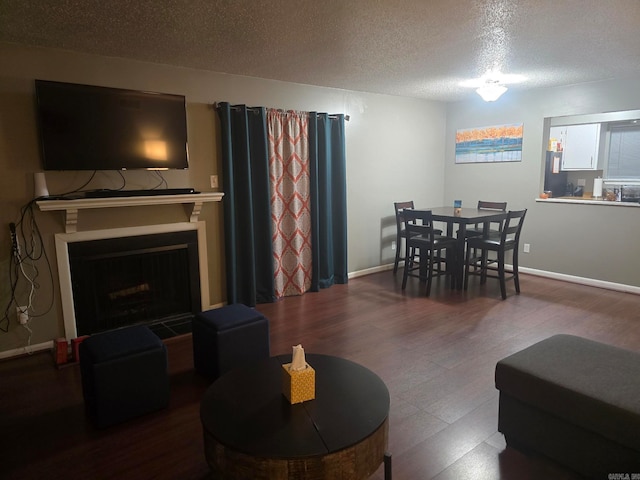 living room with wood-type flooring and a textured ceiling