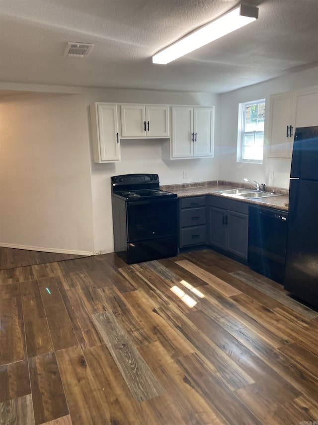 kitchen featuring blue cabinetry, sink, white cabinets, and black appliances