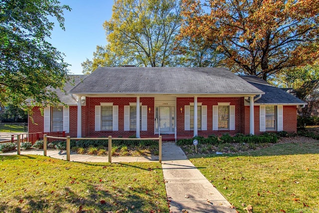 view of front of house with covered porch and a front yard