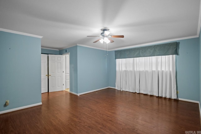 empty room featuring crown molding, ceiling fan, and dark wood-type flooring